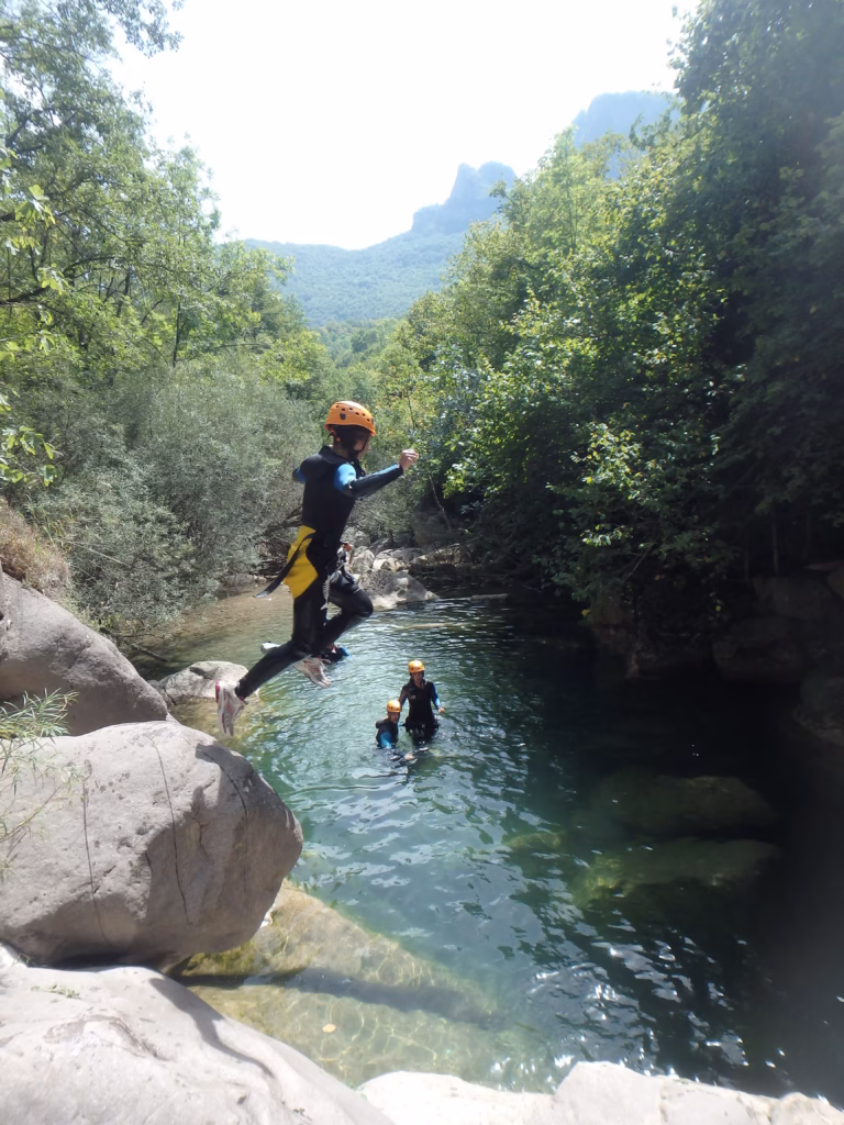 Un adolescent saute d'un rocher dans le le Gurn.